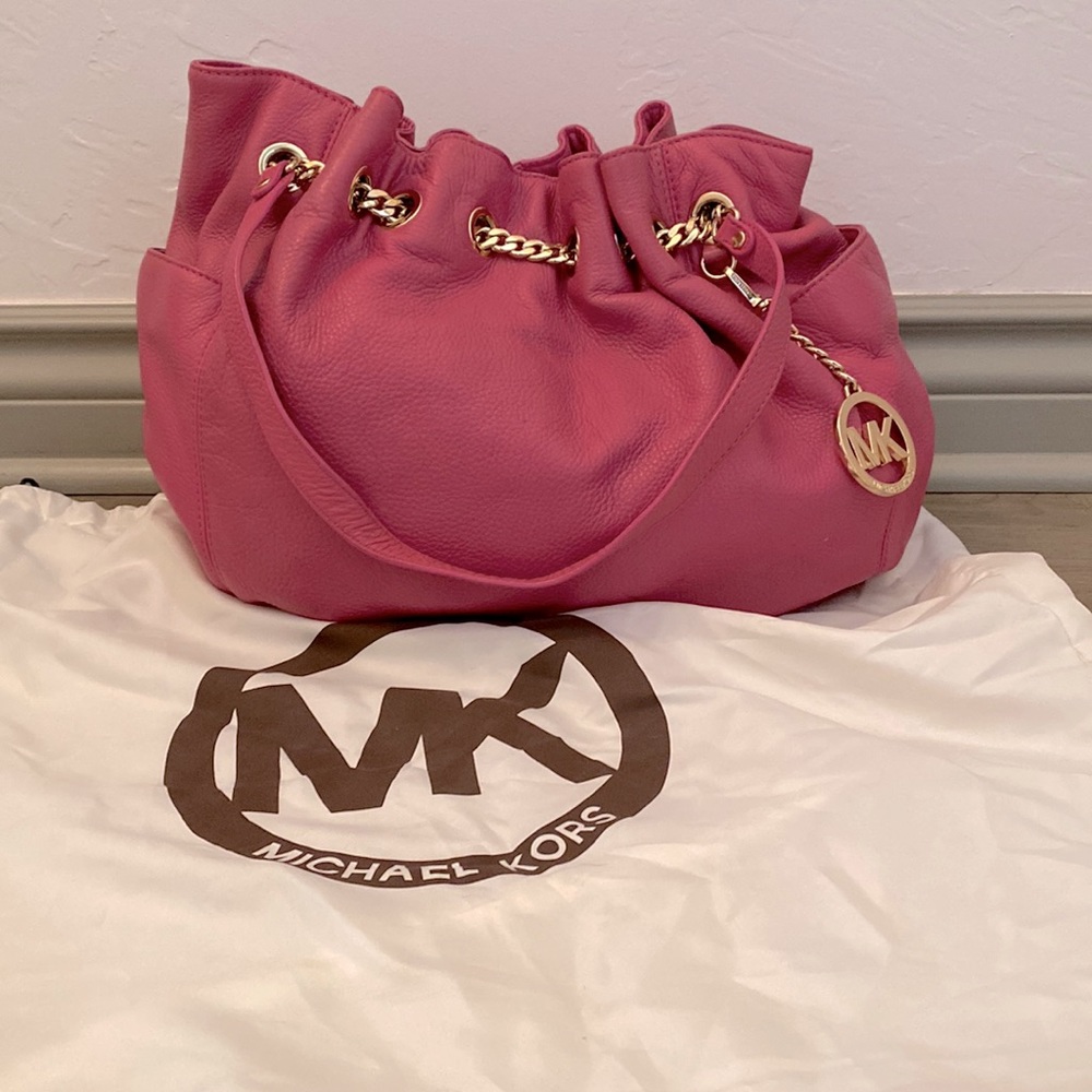 Authentic Michael Kors pink bag with gold chain closure, tan interior